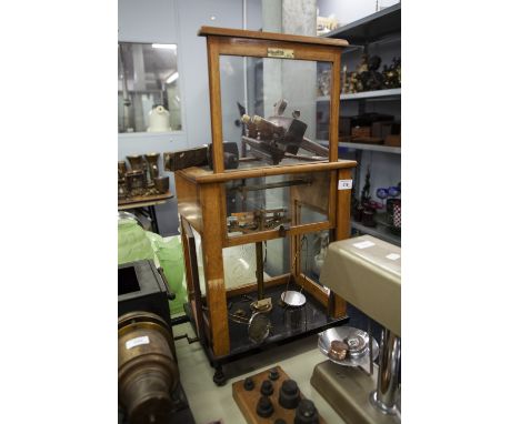 L. OERTLING LTD. LONDON, GOOD PAIR OF LABORATORY SCALES,  IN GLAZED LIGHT OAK CASE WITH BLACK VITROLITE BASE WITH SIDE ACCESS