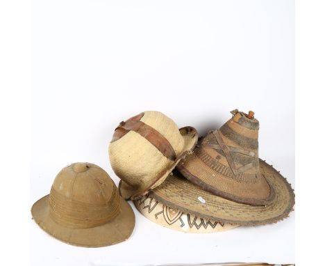 A Victorian British Army khaki pith helmet, and various African basketweave hats 