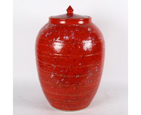 A large Chinese red glazed ceramic barrel and cover, height 47cm