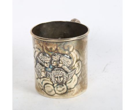 An Art Nouveau silver christening tankard, with embossed cherub decoration 