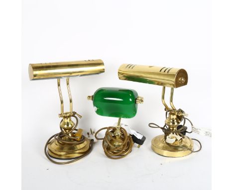 A pair of brass desk lamps with adjustable brass shades, height 33cm, and a smaller lamp with green glass shade 
