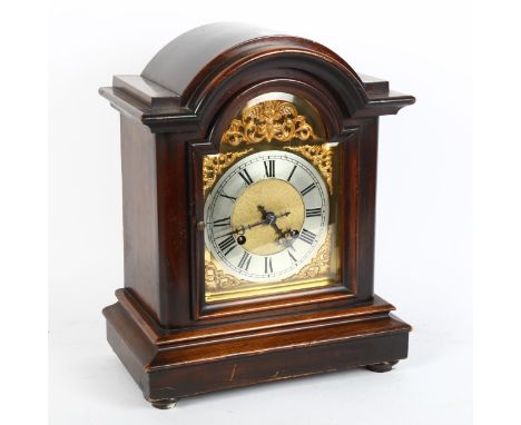A mahogany dome-top 8-day mantel clock, brass dial with silvered chapter ring, and movement striking on gong, case height 37c