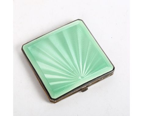 An early 20th century engine turned silver and green enamel rectangular compact 