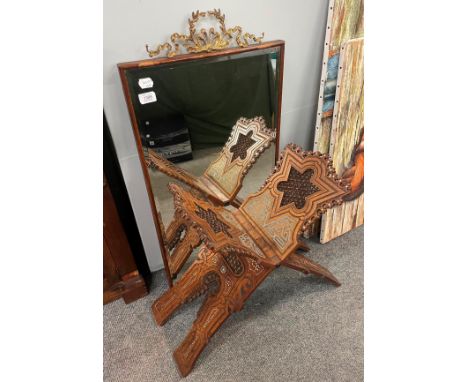 A mirror with a gilt metal ribbon-tied surmount, 45cm by 91cm together with an inlaid Middle-Eastern book or Quran stand  