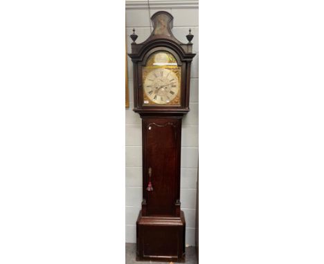 An oak eight-day long caseclock, 13'' arched brass dial with silvered chapter ring, the arch with silvered plaque bearing an 