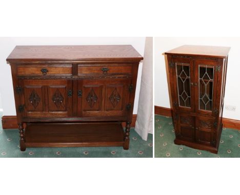 A Wood Brothers reproduction oak sideboard of two drawers above two lozenge carved cupboard doors, raised on bobbin turned fo