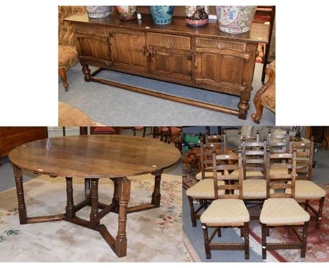 An oak dining suite in 17th century style comprising a gate leg dining table, 160cm by 160cm (open) by 73cm, a set of eight n