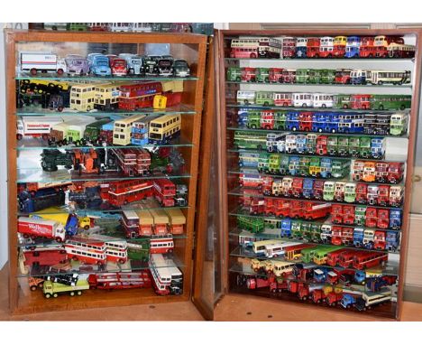 A collection of EFE buses in two collectors cabinets together with a few copycat models and a 1950's Dinky light tank