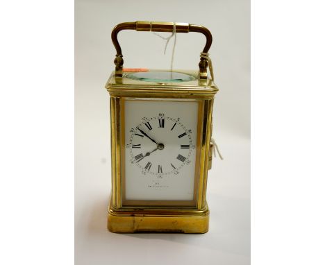 An early 20th century French lacquered brass cased carriage clock, the enamel dial with Roman numerals, signed Dent of London