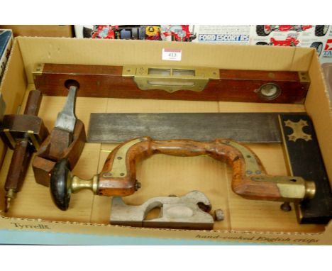 A collection of 19th century hand tools to include E Preston & Sons brass mounted level, brass mounted walnut brace, and a ro