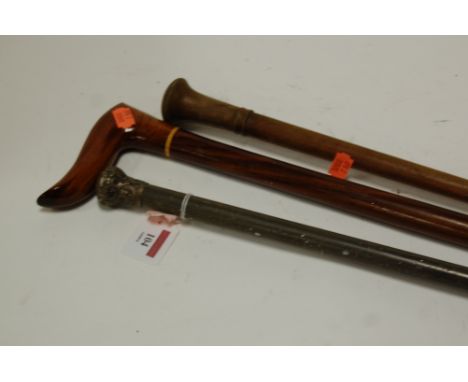 A late Victorian silver topped walking stick together with two others (3)