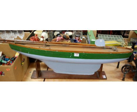 An early 20th century Pond Yacht Hull, constructed from wooden, and painted in green and light blue, with stained decking, Ma