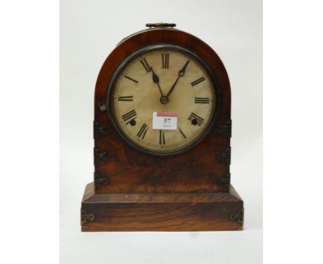 A Victorian walnut gilt metal mounted mantel clock having a paper covered dial with Roman numerals and eight day movement