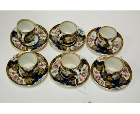 A set of six Worcester coffee cans and saucers each on a cobalt blue ground hand painted with birds and flowers, heightened i