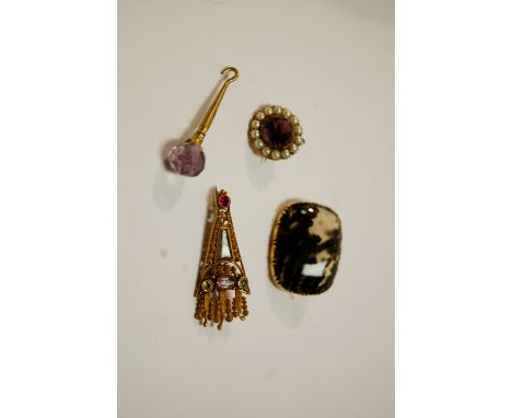 A filigree and paste set mourning brooch; together with an agate brooch; an amethyst topped button hook pendant; and an ameth