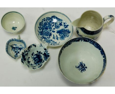 An 18th century Worcester blue & white tea bowl and saucer in the three fences pattern; together with Worcester jug and slop 