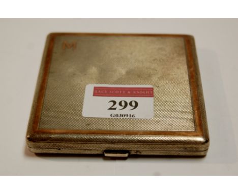 A mid-20th century silver and yellow metal ladies compact, with all-over engine turned decoration 