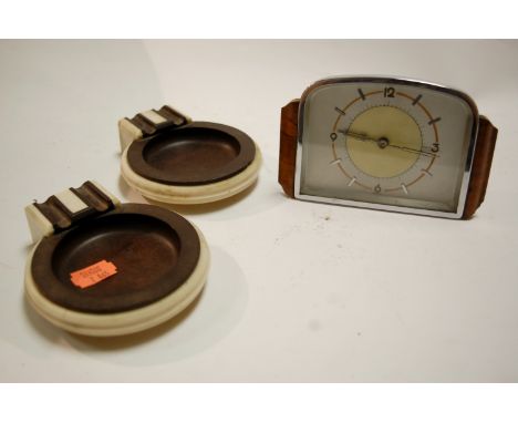 A pair of Art Deco bakelite mounted ashtrays each signed verso British Buttner Product, together with an Art Deco walnut and 