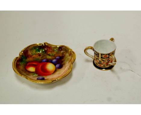 A small Royal Worcester shallow bowl hand painted with grapes and peaches signed Moseley together with a miniature Royal Crow