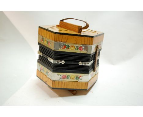 A 20th century Rosetti Rambler ten button concertina together with a handbook for the Chromatic concertina 