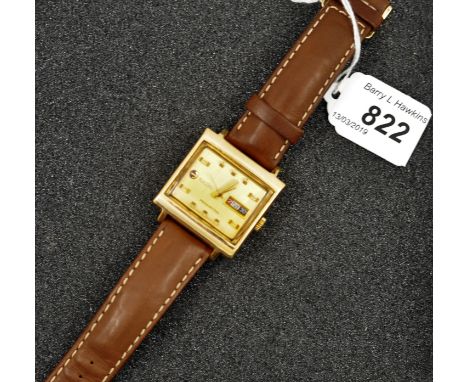 RADO MANHATTAN SQUARE GOLD COLOURED FACE WITH DATE APERTURE, SECOND HAND, LEATHER STRAP, STAINLESS STEEL BACK  