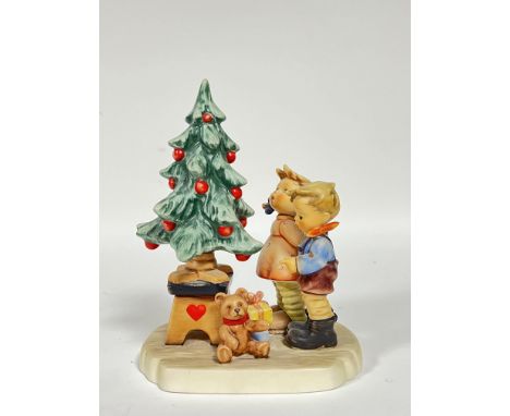 A Goebel Hummel figurine, 'Wonder of Christmas', with two children admiring a Christmas tree (marked verso, h- 17cm, w- 13cm)