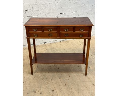 A yew wood side table with inlaid rectangular crossbanded top above an arrangement of four short and two long drawers, raised