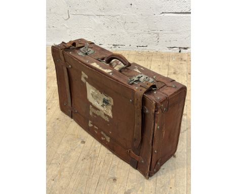 A vintage brown hide travel case with leather straps, enclosing a plain interior, shows signs of use. L x 62cm, D x 35cm