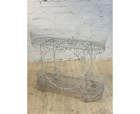 A vintage Victorian two-tier wirework and wrought iron plant stand with white painted finish decorated with scrolls and swag 