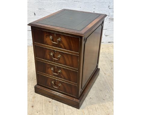 A reproduction mahogany two-drawer filing cabinet with inset green leather gilt-tooled skiver above two dummy drawers, raised