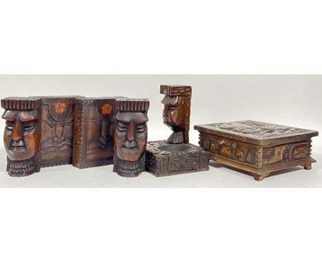 A group of Aztec style carved wooden objects including two pairs of carved heads, an ashtray, and a locking box (with key, h-