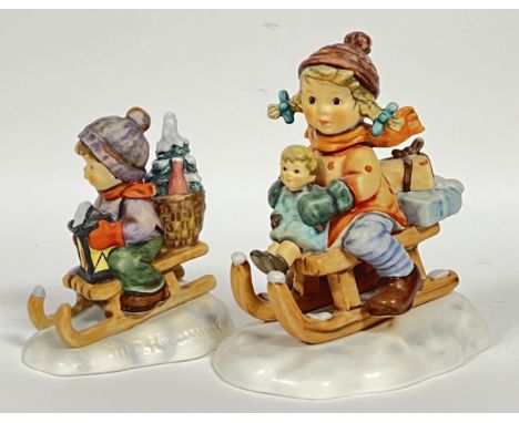 A Goebel Hummel 'Christmas Delivery' figure of a child and infant on a sledge (marked verso- no. 2014, h- 15cm, w- 13cm), tog