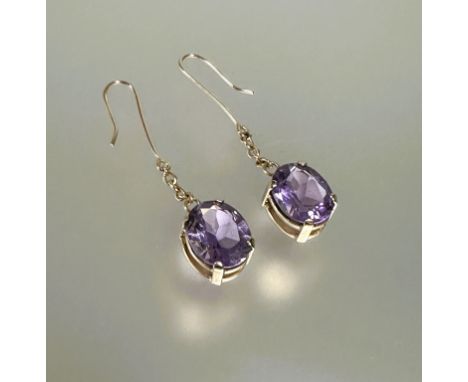 A pair of yellow metal mounted oval faceted amethyst drop earring approximately 3ct mounted in four claw setting on yellow me