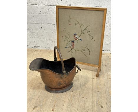 An Edwardian copper helmet shaped coal bucket with swing handle to top and scrolling reed handle. H x 28cm, L x 41cm., togeth