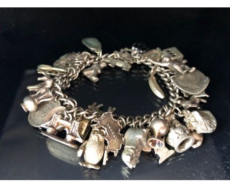 Silver charm bracelet with a large quantity of charms total weight 79g