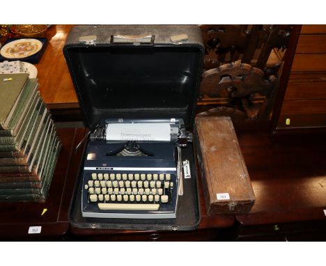 A vintage manual portable typewriter and an old blood pressure machine 