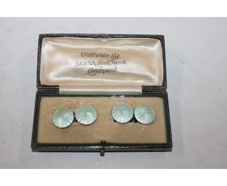 A pair of white and yellow metal cuff links with enamel decoration 