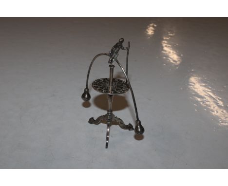 A Dutch silver roulette man, raised on tripod base