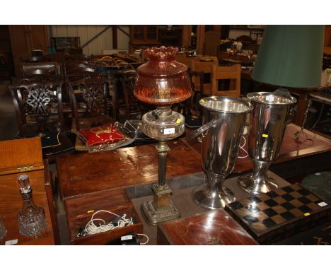 A Victorian table oil lamp supported on a brass Corinthian column and onyx base, with ruby tinted shade 
