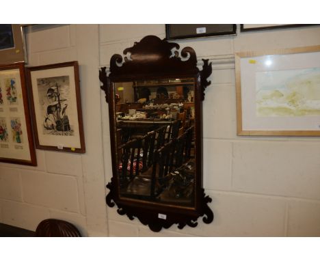 A mahogany Chippendale style fret carved wall mirror 