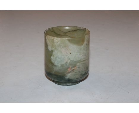 A jade coloured polished stone cup 