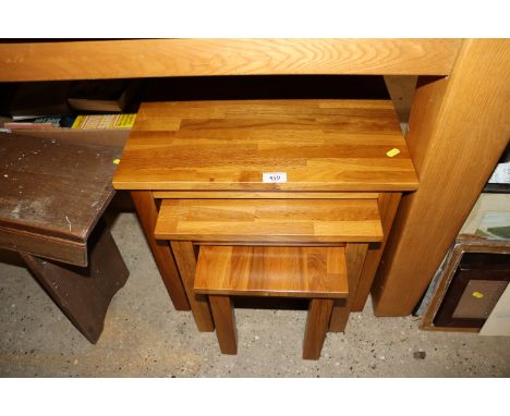 A nest of light wood coffee tables