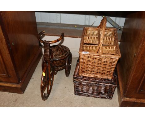 A wicker and bamboo tricycle plant stand; a wicker hamper; and a wicker six bottle wine basket