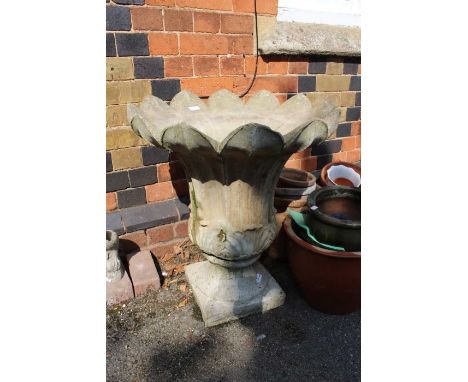 A large concrete scalloped lotus pedestal planter
