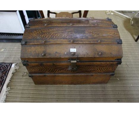 A decoratively painted dome top tin trunk containing a deed box, a letter rack, and two unframed pictures