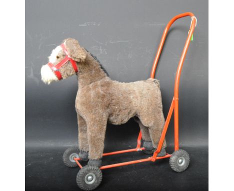 An original vintage Lines Bros of Ireland ride along / push along donkey / mule. The donkey a brown mohair example with beade