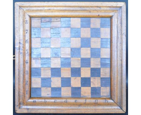 A large 19th century inlaid wooden folding chess board having an inlaid wood chess board atop opening to reveal a backgammon 