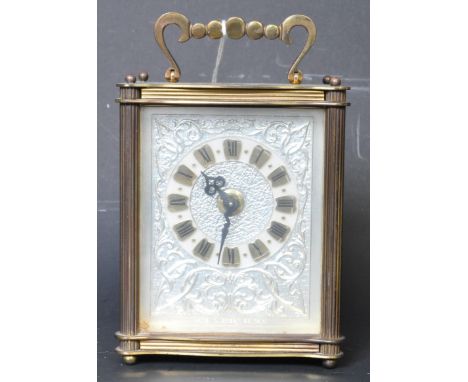 A 20th century Smiths brass cased carriage clock. the clock face having roman numeral to the chapter ring and silvered metal 