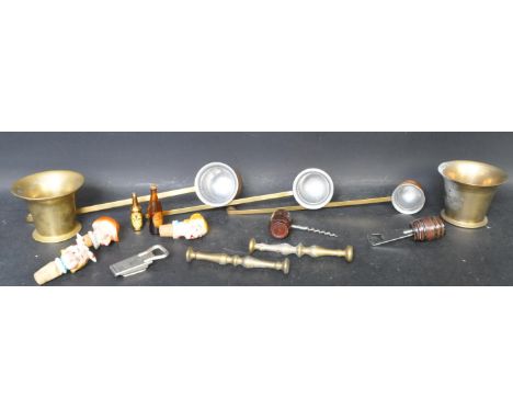 A collection of vintage 20th century brass curios comprising of a two 19th century pestle and mortars, three sprits serving l