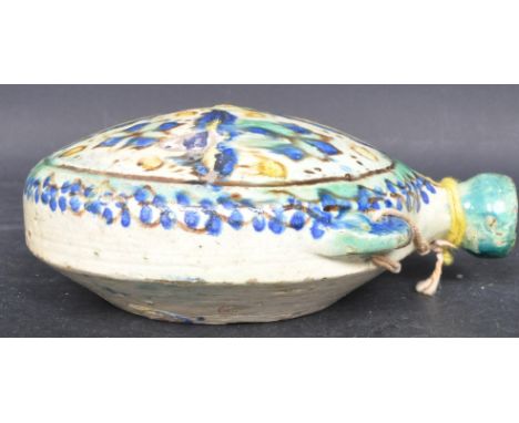 An early 20th century Persian hanging ceramic earthenware moon flask being hand painted with a mosaic type design. Some chips